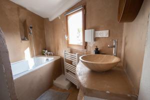 a bathroom with a tub and a large bowl sink at Le ciel du Palais - Intramuros - 2 ch - Wifi in Avignon +27 photos