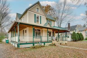 a large house with a porch and a yard at Eau Claire Retreat Close to Chippewa Riverfront! in Eau Claire