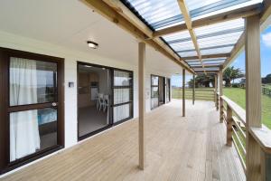 an open deck with a glass roof on a house at Apartment 1 in Auckland