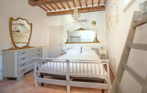 a bedroom with a white bed and a mirror at Spello House Altana in Spello