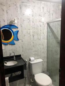 a small bathroom with a toilet and a sink at Pousada D Italia in São José da Coroa Grande