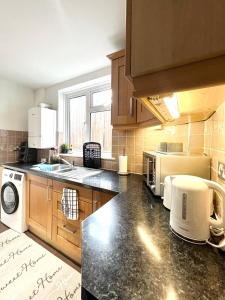 una cucina con lavandino e piano cottura forno superiore di 3 Bedroom House in Rochester Strood with Wifi and Netflix Walking distance to Strood Station a Wainscot