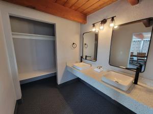 a bathroom with two sinks and a mirror at Saltwater Inn in Westport