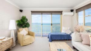 a living room with a bed and a couch at Alcheringa - Units 3 & 4 32 Sandy Point Rd in Corlette