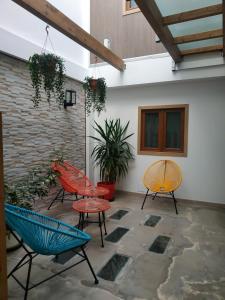 a patio with chairs and tables and a brick wall at Alojamiento Gofioplaya in Arinaga