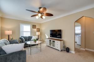 a living room with a couch and a tv at Quaint Cedar Rapids Home, 4 Mi to Downtown! in Cedar Rapids