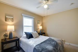 a bedroom with a bed and a ceiling fan at Quaint Cedar Rapids Home, 4 Mi to Downtown! in Cedar Rapids