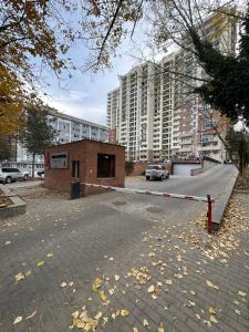 a parking lot with a building in a city at Jikia Residence in Tbilisi City