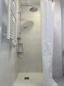 a shower in a bathroom with a glass door at Balcon San Rafael in Córdoba