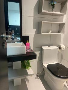 a bathroom with a white sink and a toilet at One way in João Pessoa