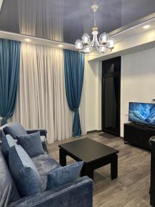 a living room with a couch and a table at Jikia Residence in Tbilisi City