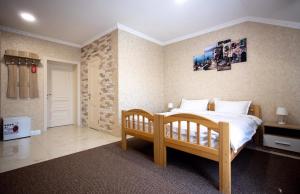 a bedroom with a wooden bed in a room at Готель River House in Umanʼ