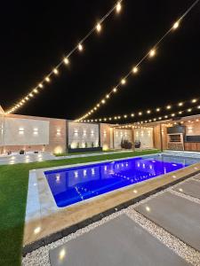 a swimming pool at night with lights above it at Cabaña la arenosa in Barranquilla
