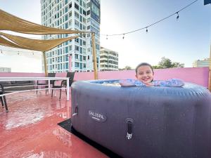 a young child is laying in a inflatable at 610@Miramar in San Juan