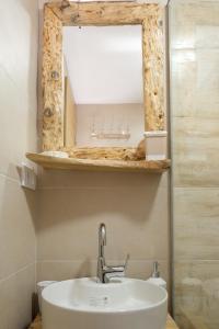 a bathroom with a sink and a mirror at Villa Zagorka and mountain houses A, M, D in Kopaonik