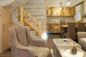 a living room with two chairs and a table at Villa Zagorka and mountain houses A, M, D in Kopaonik