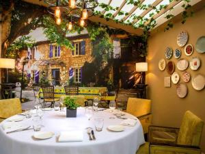 a dining room with a table with plates on the wall at Sofitel Saigon Plaza in Ho Chi Minh City