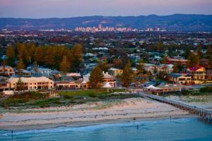 a view of a beach with a city in the background at Two roomed private suite in front of cottage in Grange