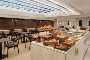 a bakery with a buffet of bread and pastries at Hilton London Metropole in London