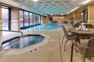 a swimming pool with a table and chairs and a table and a tablesktop at Drury Inn & Suites Birmingham Grandview in Birmingham