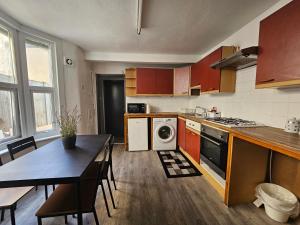 a kitchen with a table and a dining room at Family room near Queen Mary College in London