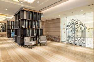 a lobby with chairs and a gate in a building at DoubleTree by Hilton Doha Downtown in Doha