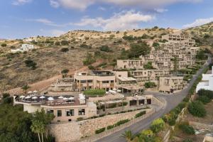 uma aldeia ao lado de uma colina com casas em Domes Aulus Elounda All-Inclusive Resort, Curio by Hilton em Elounda