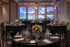 a ballroom with tables and chairs with flowers on them at Hotel NoMa, Trademark Collection by Wyndham in New Rochelle