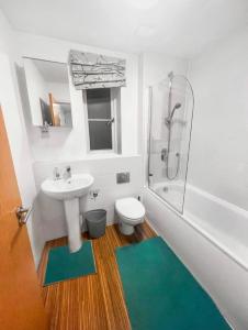 a bathroom with a sink and a toilet and a shower at Private Rooms at Oxley Comfy House - Milton Keynes in Broughton