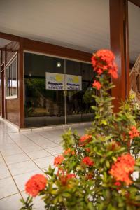 a store front with flowers in front of a building at Pousada do Romildo in Fernando de Noronha