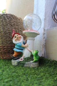 a gnome and a frog next to a snow globe at Apartament Beauty Smarald by Cosmopolis in Ştefăneştii de Jos +11 photos
