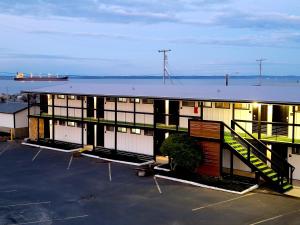 a building with a lot of windows and a large body of water at Saltwater Inn in Westport