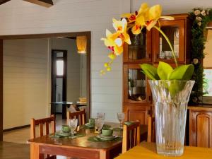 a vase filled with flowers sitting on top of a table at Pousada Jardins in Santarém