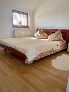 a large bed in a bedroom with a wooden floor at Nautilus in Uzhhorod