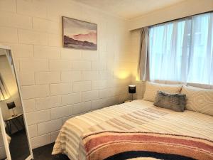 Un dormitorio con una cama grande y una ventana en CQN's en Wellington