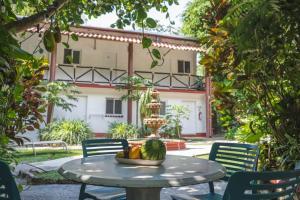 a table with a bowl of fruit in front of a building at River Front Casa Antahkarana Nogalito Hotel Room 6 in Puerto Vallarta