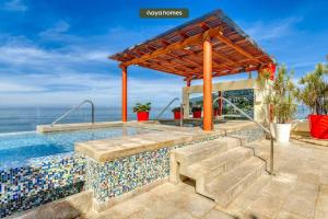 a swimming pool with a tile floor and a swimming poolvisor at Chic Studio w/Rooftop Pool - Ocean View - King Bed in Puerto Vallarta