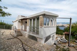 a house with a view of the water at Apartments by the sea Sveti Marko, Pag - 21654 in Pag