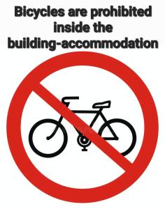 a sign that says bicycles are prohibited inside the building accommodation at Studio V3st & Parking in Larisa