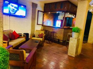 a room with a bar with a couch and a table at Salty Seahorse Mount Lavinia in Watumulla