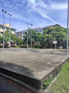 an empty parking lot with buildings in the background at Anna温馨公寓式的住宅 in Kuching