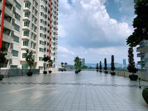 a large building with a courtyard with potted trees at Corner KL Pool View RC Residence in Kuala Lumpur