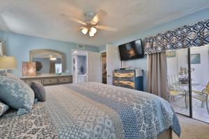 a bedroom with a bed and a ceiling fan at Sea Woods 3 Bedroom 2 Bath in New Smyrna Beach +32 photos