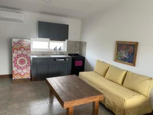 a living room with a couch and a table and a kitchen at La Higuera con Parking B in Azul