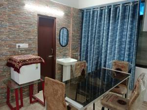 a bathroom with a glass table and a sink at Eastern guest house in Patna