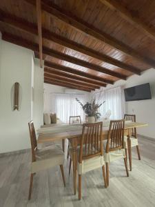 Un comedor con mesa y sillas de madera. en Los Narvales Chapadmalal, en Mar del Plata