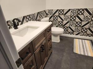 a bathroom with a sink and a toilet at Luxury Waterfront Cottage on Little Doe Lake in Burks Falls +30 photos