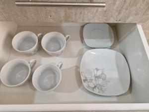 a group of four cups and bowls on a shelf at Ecos del Manantial in Villarrica