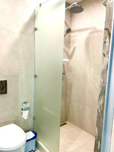 a bathroom with a shower and a toilet at Апарт-отель напротив ботанического сада in Astana