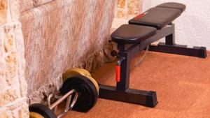 a gym bench with a dumbbell next to a wall at Entire Cozy Basement Studio in Winnipeg South Transcona in Winnipeg